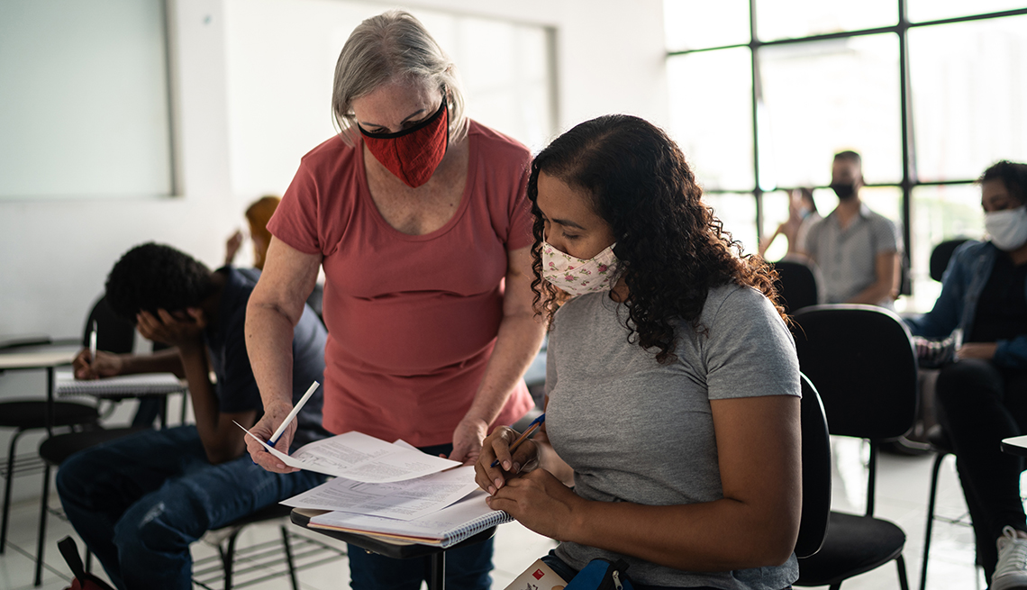 A teacher helping a student in class