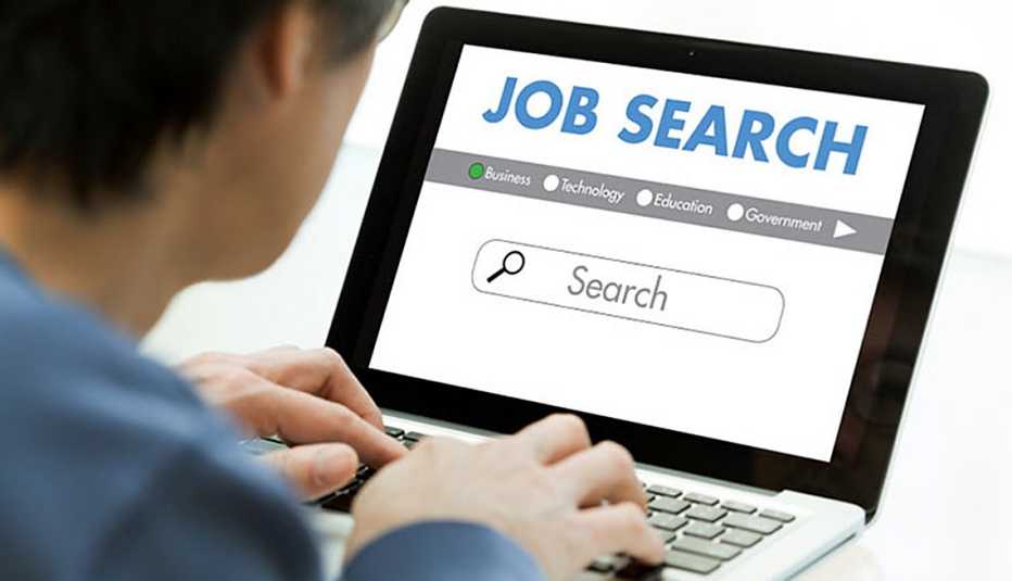 Person using a laptop computer to search for a job on a website.