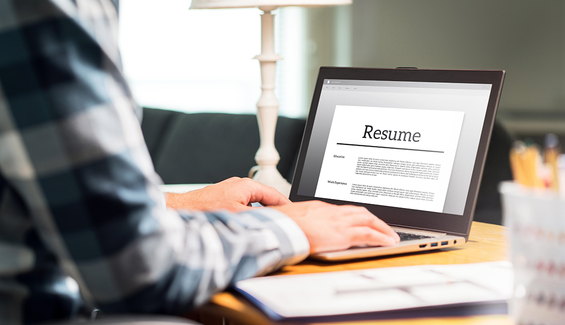 A man sitting at his desk working on his resume