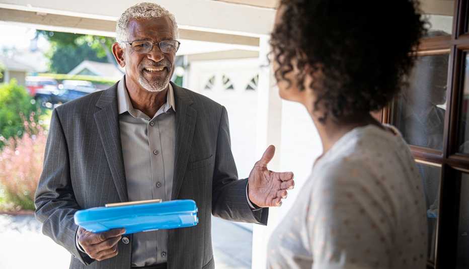An older black man talks with a younger woman