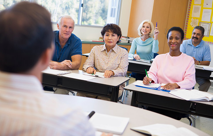 Kick Start Your Career - Mature female student raising hand in class