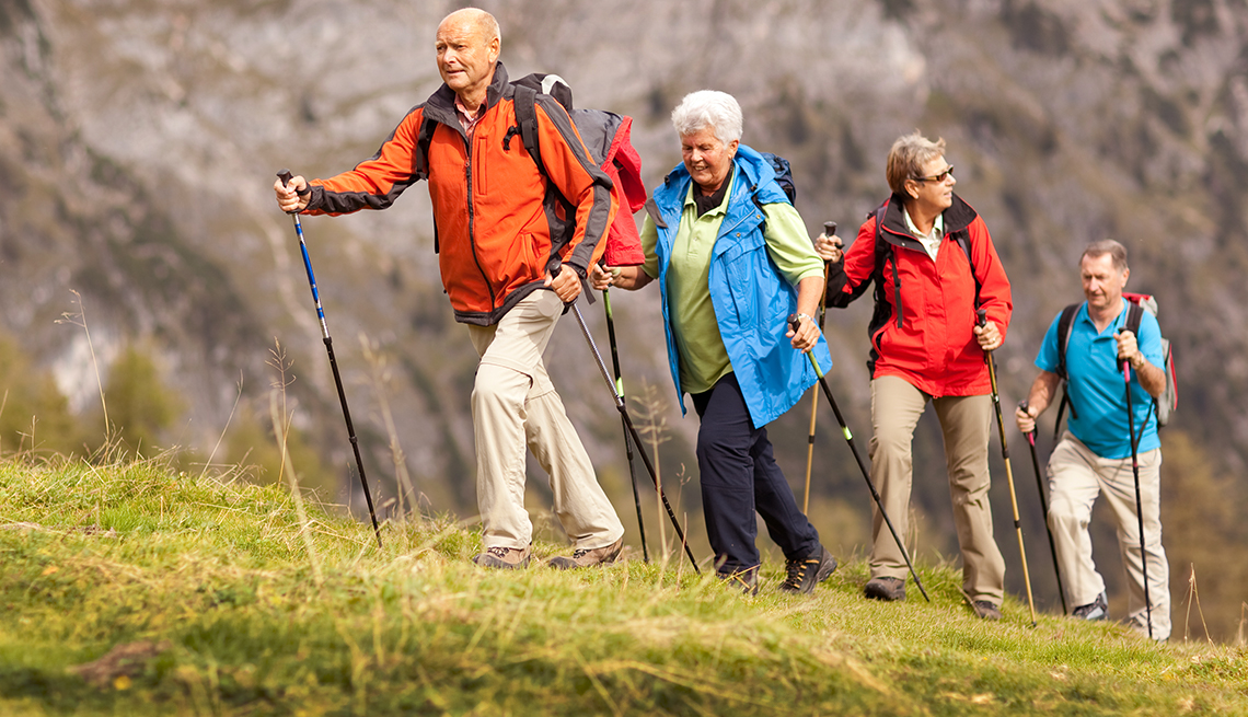 group of mature adults walking in nature 
