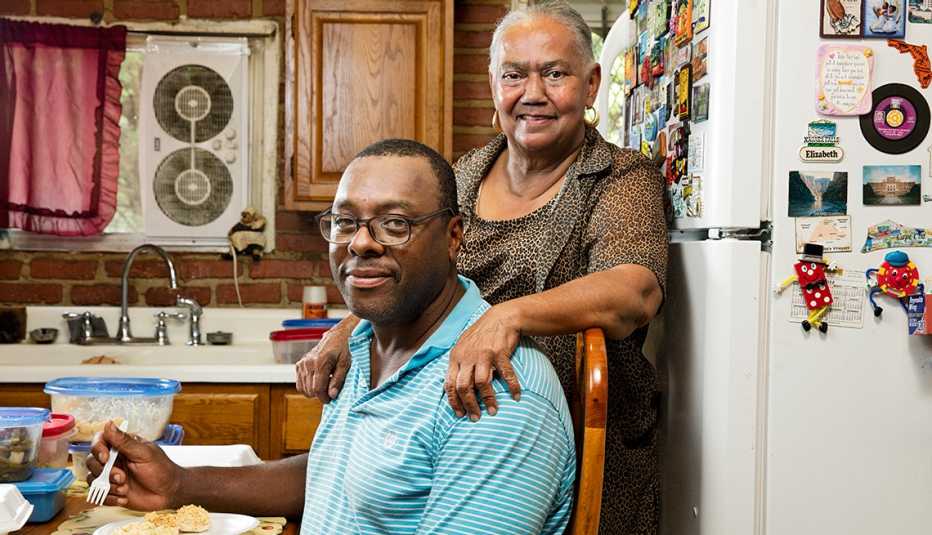 Alethea Booze, right, makes dinner for neighbor Patrick Scott in Baltimore’s Sandtown neighborhood.  