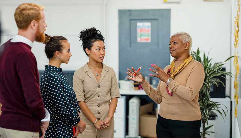 A group of people talking in an office