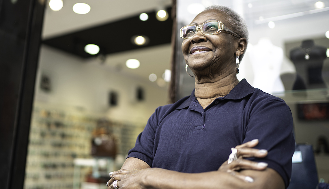 A woman stands in front of her business