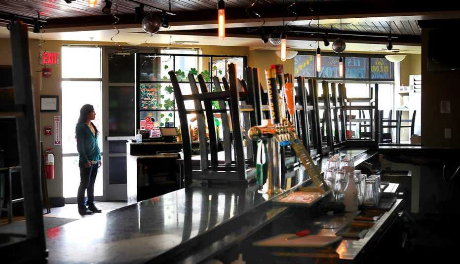A woman stands in an empty restaurant A woman stands in an empty restaurant