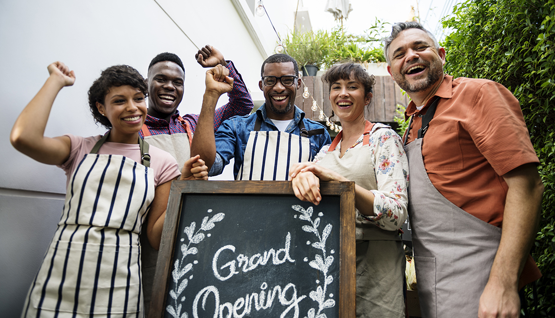 a group of people celebrate the opening of their business