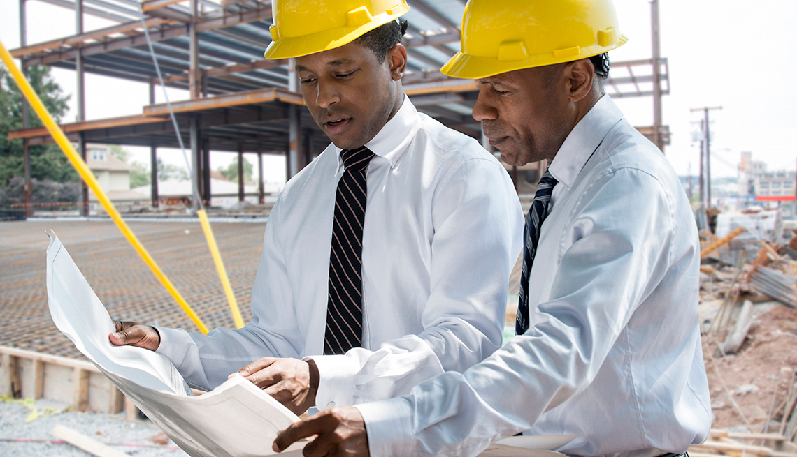 two african americans work at a construction site 
