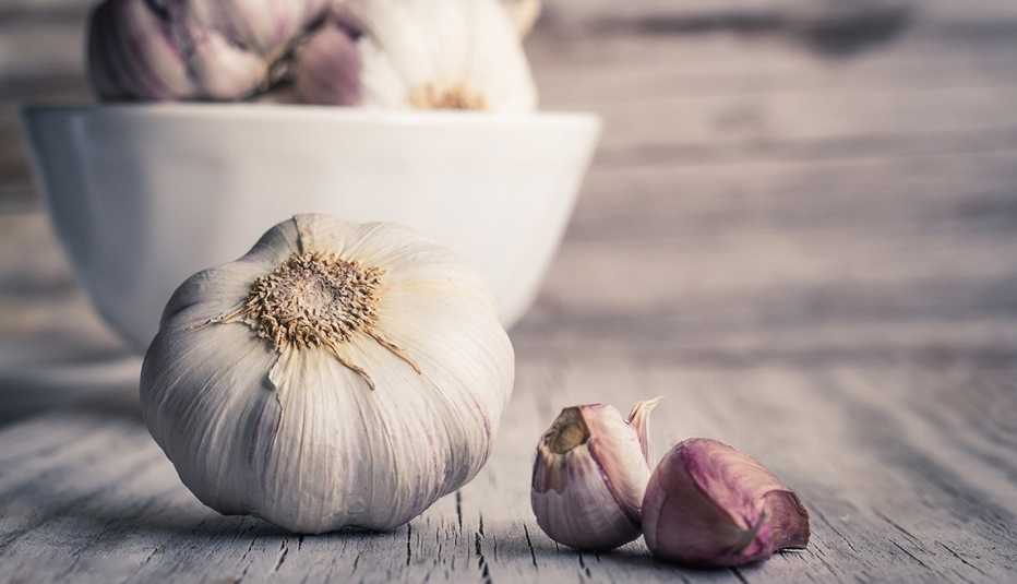 Alimentos que debes evitar antes de una salida romántica - Dientes de ajo sobre una mesa