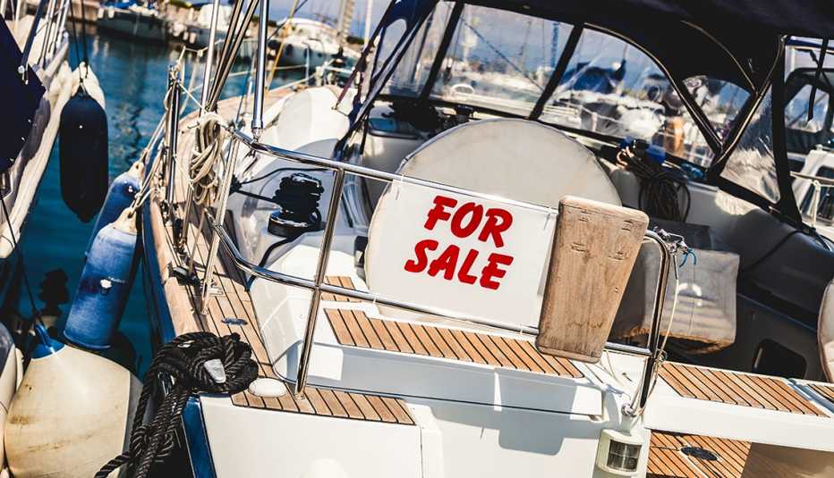 bote de pesca con un letrero que dice se vende en una marina