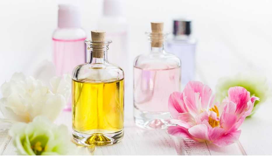 Frascos de vidrio con aceites faciales con unas flores a los lados. Frascos de vidrio con aceites faciales con unas flores a los lados.