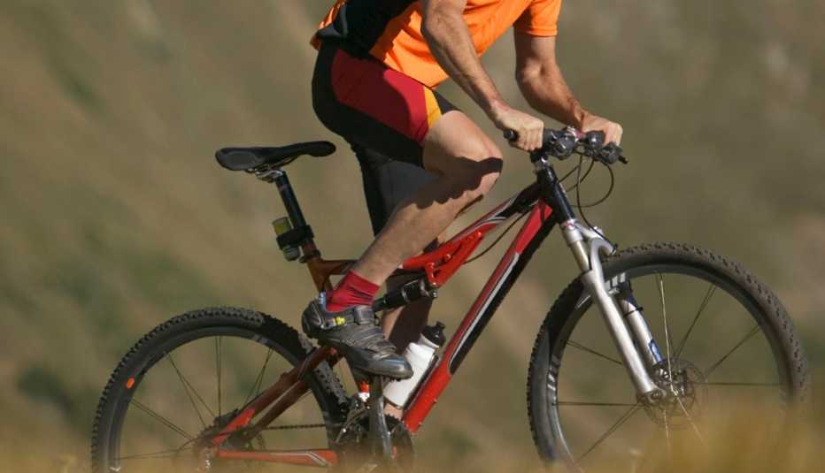 Man Riding Bicycle Up Hill, AARP Home And Family, Sex And Intimacy, Bicycling And Men's Sexual Health Man Riding Bicycle Up Hill, AARP Home And Family, Sex And Intimacy, Bicycling And Men's Sexual Health
