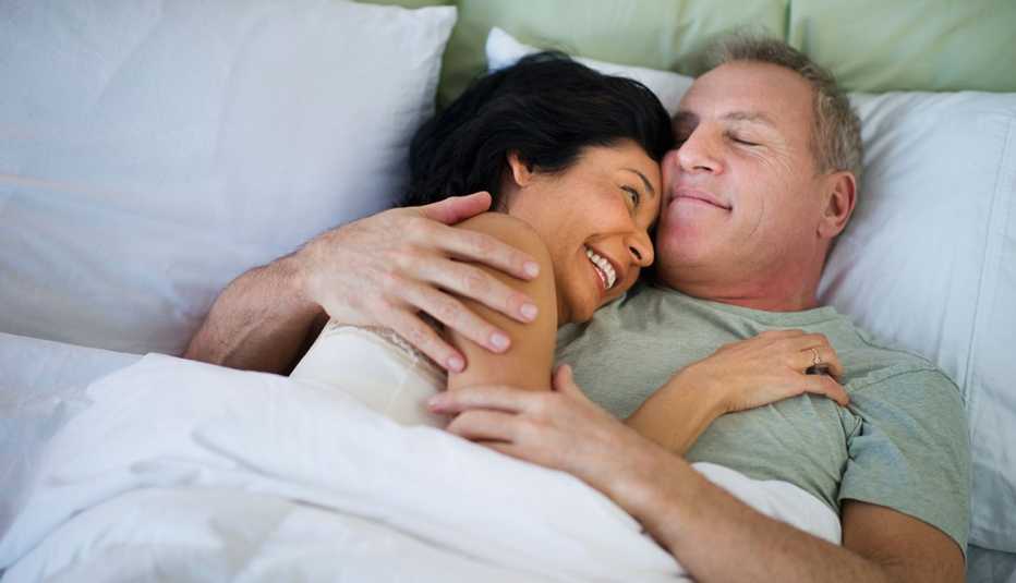 Couple Hug And Laugh In Bed Together, AARP Home And Family, Relationships, Sex And Intimacy, Which Comes First? Desire Or Sex? Couple Hug And Laugh In Bed Together, AARP Home And Family, Relationships, Sex And Intimacy, Which Comes First? Desire Or Sex?