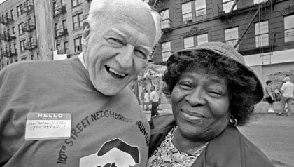 El reverendo Norm Eddy sonríe en la parroquia de East Harlem, junto a una mujer mayor