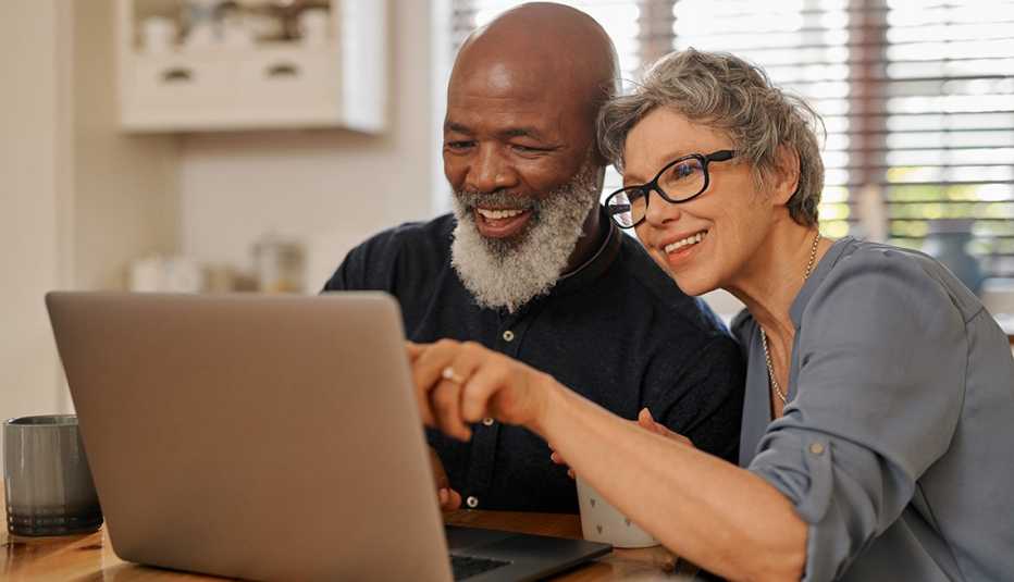 Un hombre y una mujer miran una pantalla de computadora