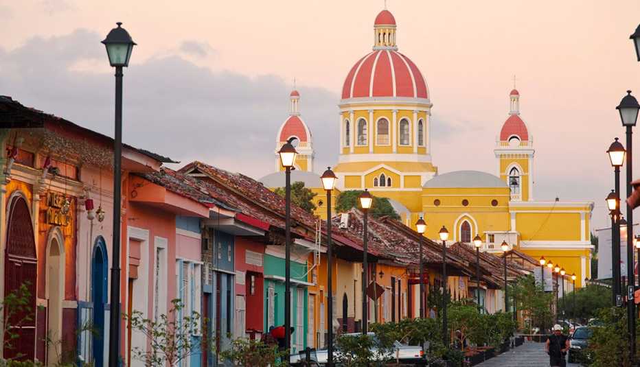 Town Street With Colorful Houses And Church In Background In Grenada Nicaragua, Cheap Places To Retire
