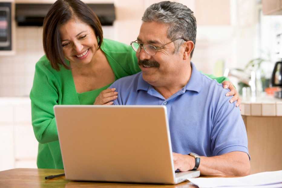 Man and woman looking at a laptop computer