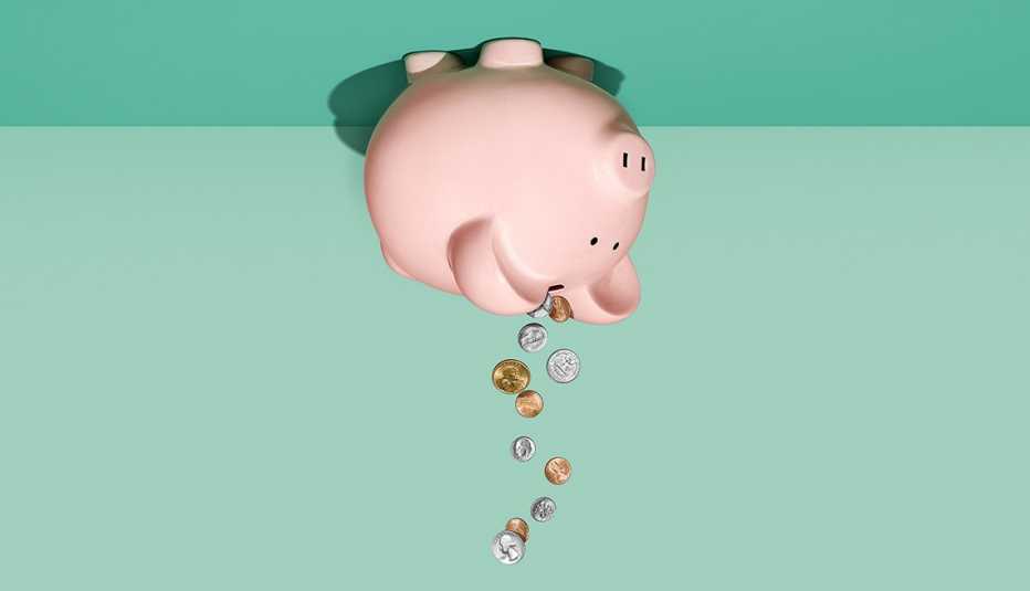Ilustración de una alcancía de cerdito boca arriba de donde caen monedas.