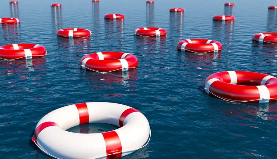 Flotadores blancos y rojos de salvavidas sobre el mar
