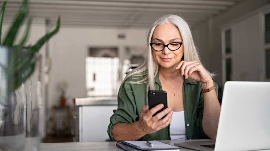 woman working from her home office with aarp tech discounts