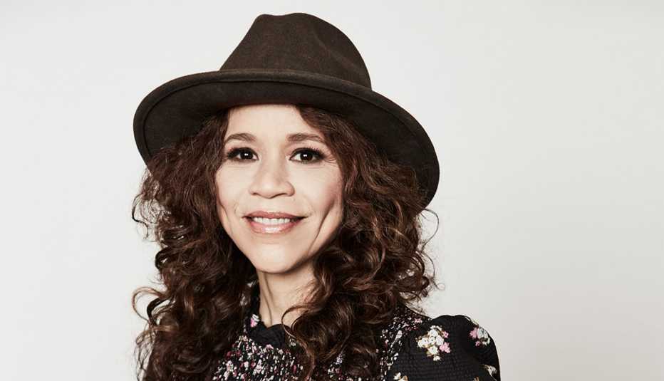 woman with curly hair wearing hat