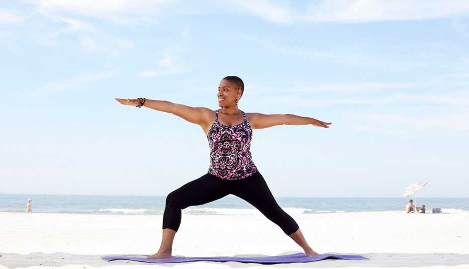 Woman practicing yoga on beach Woman practicing yoga on beach