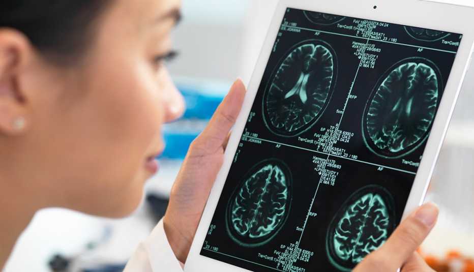 Riesgos y beneficios de los ensayos clínicos - Mujer observa exámenes médicos
