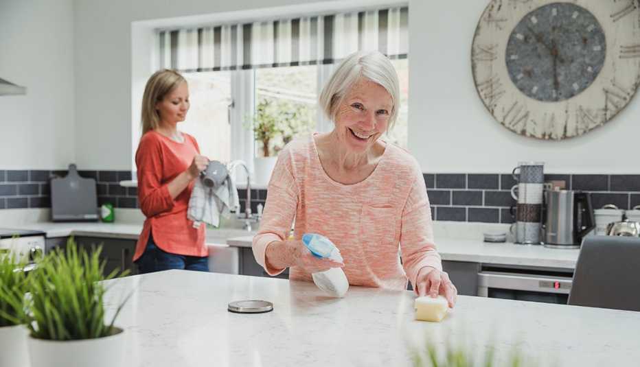 Una mujer y su hija limpian y desifectan su cocina