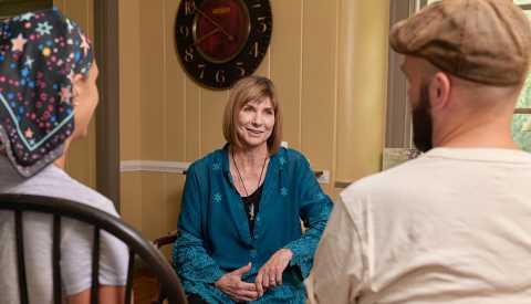 Kris Kington Barker comadrona especialista en el final de la vida habla con una pareja.