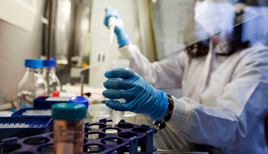Una mujer con un tubo de ensayo en un laboratorio Una mujer con un tubo de ensayo en un laboratorio