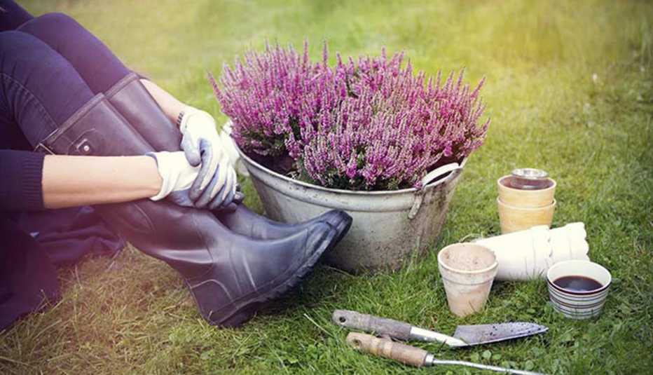 Mujer tomándose un descanso luego de trabajar en el jardín Mujer tomándose un descanso luego de trabajar en el jardín