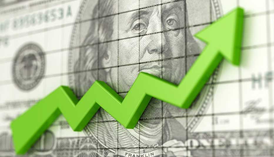 Línea verde hacia arriba frente a un billete de $100 dólares Línea verde hacia arriba frente a un billete de $100 dólares