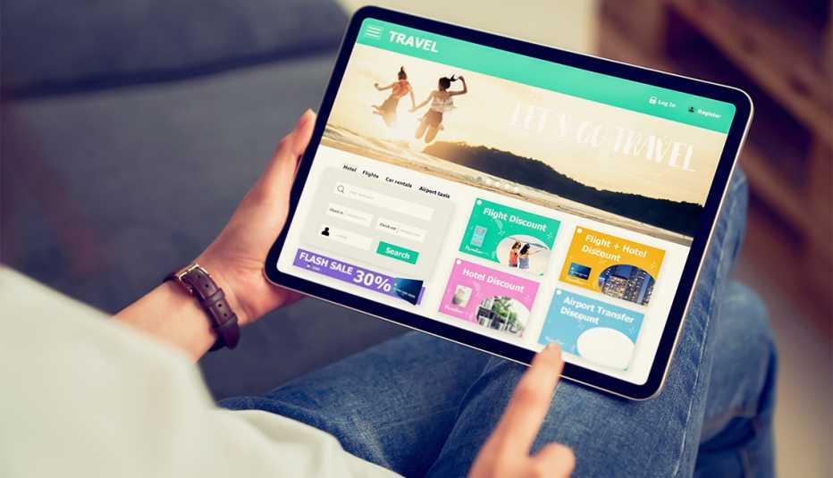 Persona sostiene una tableta digital que muestra una aplicación de reservas para turistas