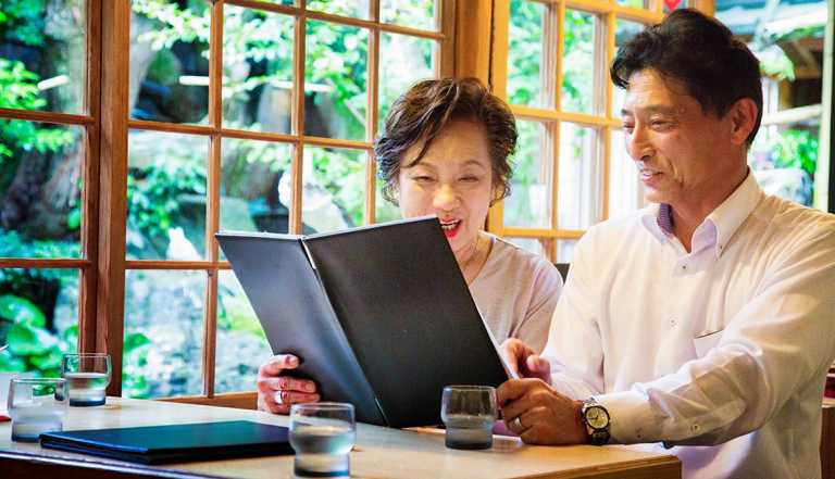 couple looking at a menu at a restaurant