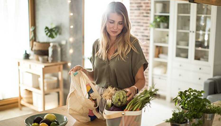 A woman unpacking her groceries at home