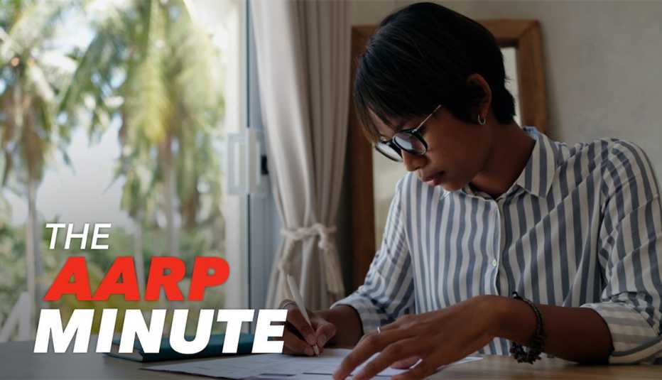 a woman at home siting at a desk writing