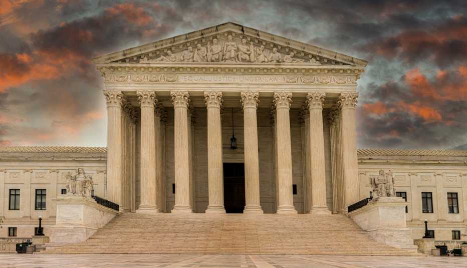 Rain clouds pass over the Supreme Court leaving the grounds wet and storm clouds colorful.