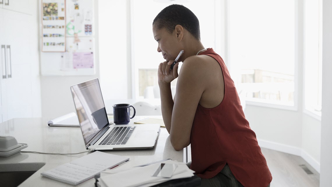 woman at desk looking at computer