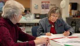 Marylou Murray, Tax Aide volunteer works with a client at AARP Foundation Tax Aide service in Culpeper, Virginia on March 13, 2025.