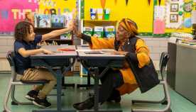 Woman reading to a child in a classroom
