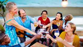 A group of people drinking together on the beach