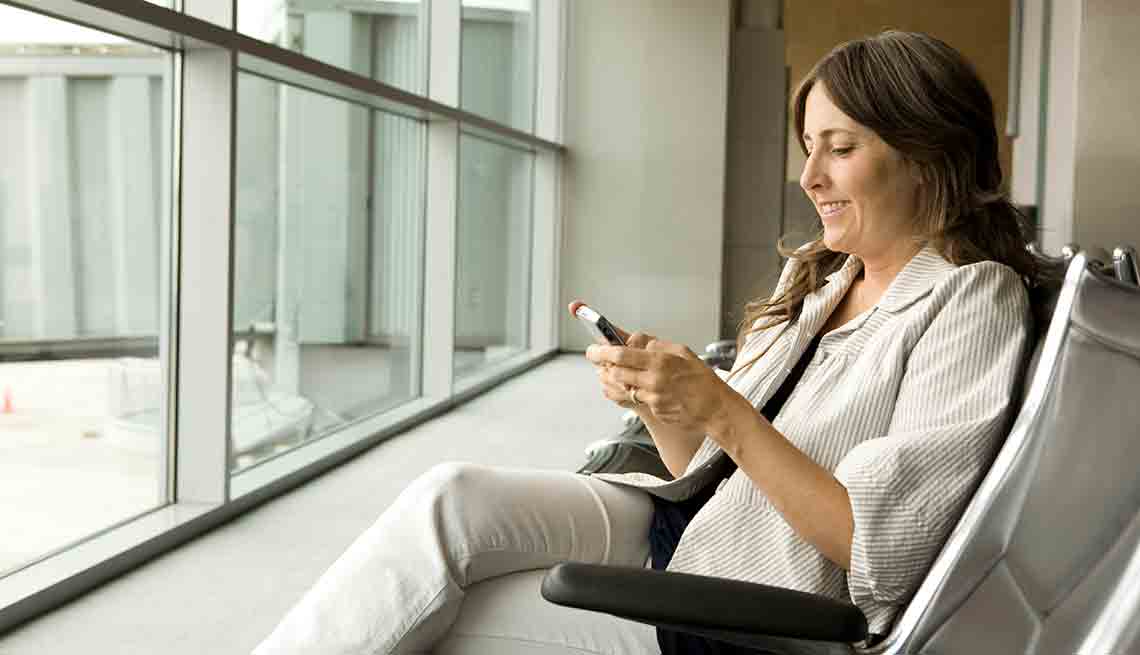 Mujer viendo el teléfono - Las mejores aplicaciones para volar