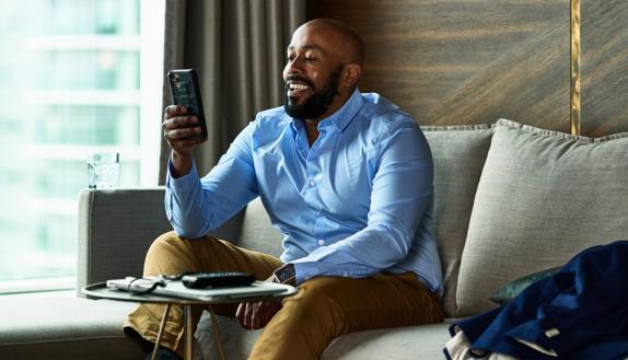 man smiling and looking at phone