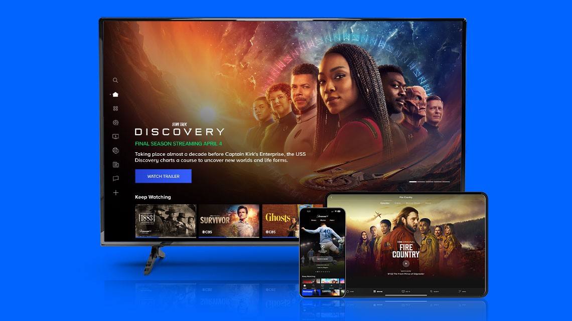 Discovery tv show home screen image on flat screen tv,  Fire Country show on tablet screen, sports theme screen on mobile phone, all on blue background