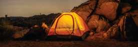 a tent illuminated at Joshua Tree National Park