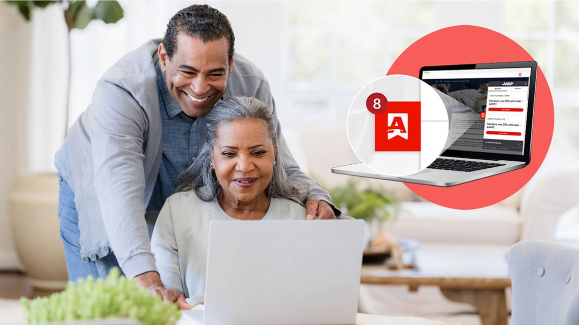 man standing behind woman sitting looking over her shoulder smiling as the both look at an open laptop, in corner laptop open over red circle, magnifying the extension on screen notification symbol