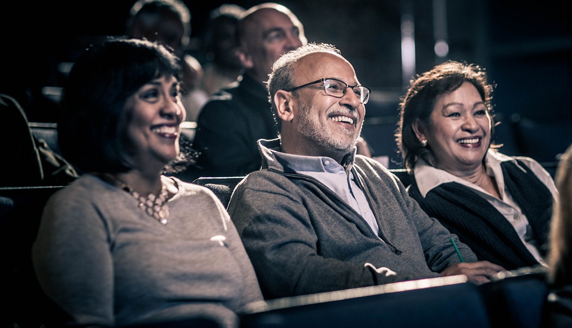 Tres adultos mayores disfrutando una película