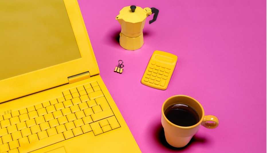 image of yellow laptop, coffee pot and mug