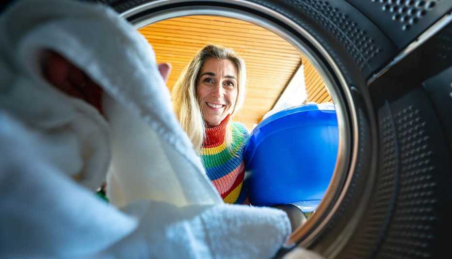 woman smiling and looking into the dryer