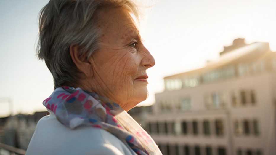 A woman looking out on the rooftop of a building